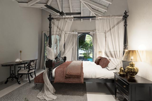Luxurious bedroom with four-poster bed & garden view at IF Villa