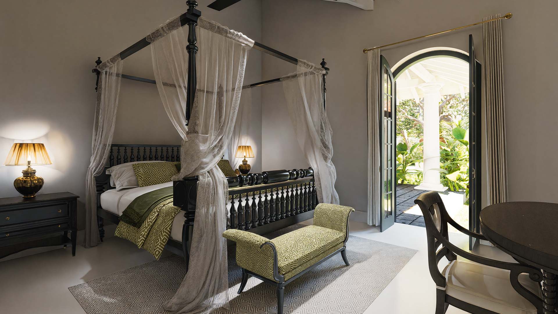 Luxury bedroom opening to lush greenery view 