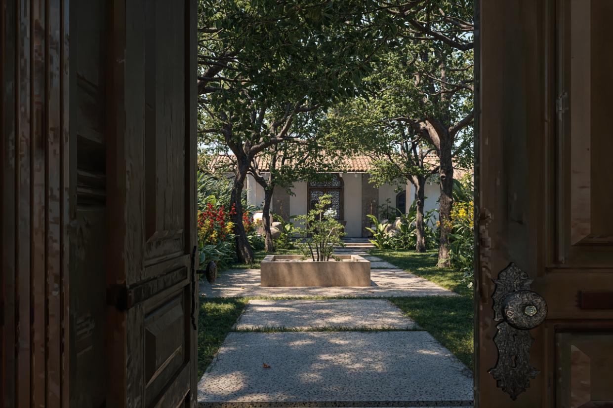 IF Villa lush garden framed by wooden doors